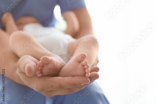 Male doctor holding baby at hospital