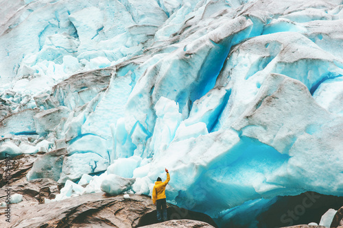 Traveler Man enjoying Nigardsbreen glacier view Travel Lifestyle getaway concept adventure extreme vacations outdoor nature in Norway