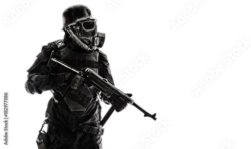 Futuristic nazi soldier sentinel gas mask and steel helmet with schmeisser handgun isolated on white studio shot standing to attention profile