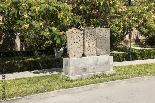 Stone cross in Echmiadzin (Vagharshapat) made of red stone tufa. ,