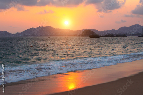 Sunset, ocean waves and beach, Acapulco, Mexico