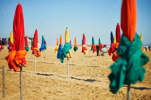 Many colorful umbrellas on the beach of Deauville