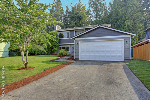 Lovely grey rambler house exterior features grey siding