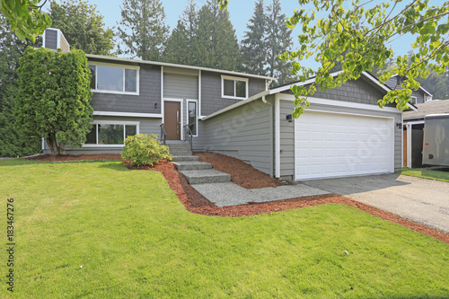 Lovely grey rambler house exterior features grey siding