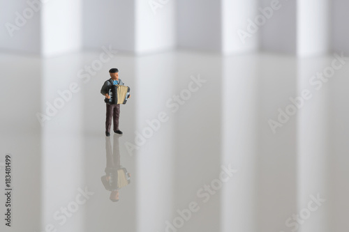 Sailor playing a sad song on his accordion - miniature figure