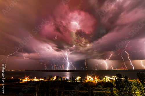 A huge number of bright and terrible lightning over the river.