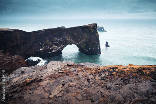 Natural rocky arch. Scenic landscape of Iceland
