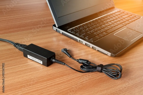 adapter power charger of laptop computer On a wooden table