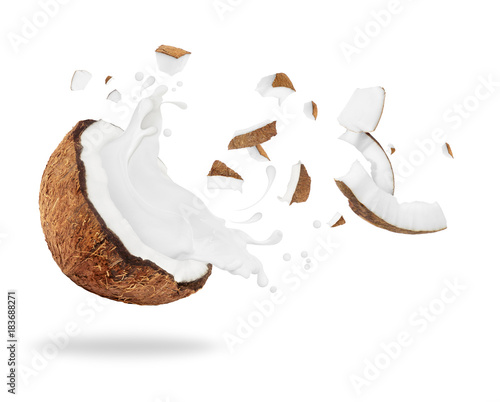 Broken coconut with milk splash, isolated on white background