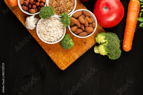 Fresh raw vegetables with nuts and cereals for cooking or eating. Vegetarian food. Top view