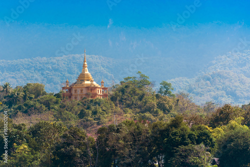View of a buddhist temple in the middle of the forest in Louangphabang, Laos. Copy space for text.
