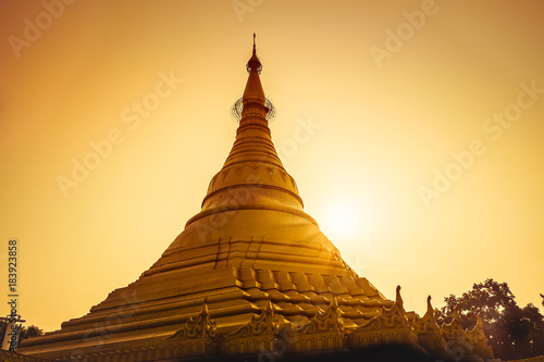 magical sunset golden with a buddhist stupa in nepal.