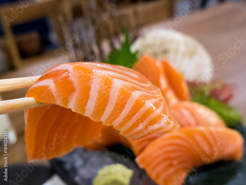 Salmon sashimi with chopsticks 1