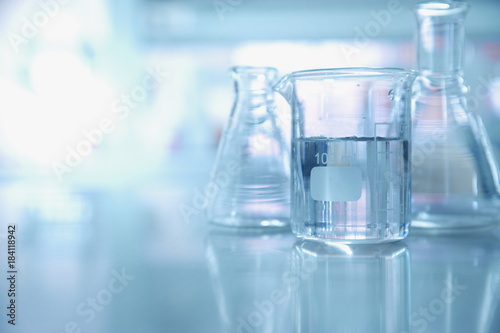 experiment water in beaker and flask in chemistry science laboratory background