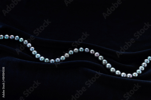 black pearl on dark blue velvet