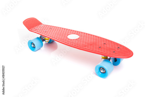 Red plastic skateboard on white background