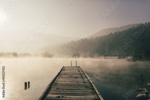 Mysterious lake on an early winter morning photographed in backlight in central Slovenia
