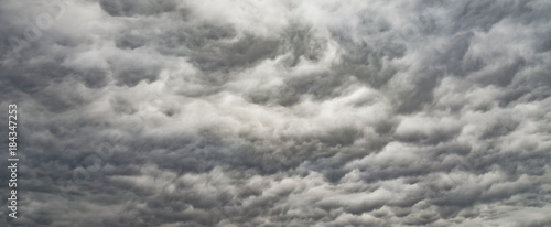 The panorama of overcast texture with clouds. Copy space.A lot of clouds in dramatic filter.