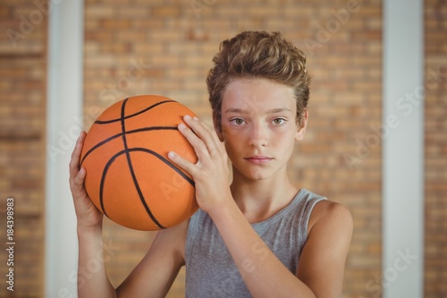 Determined boy holding a basketball