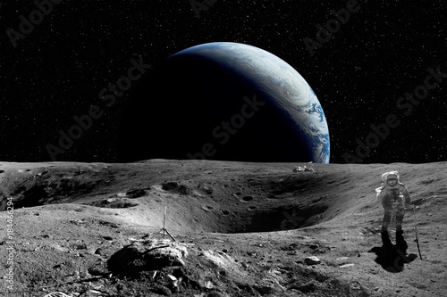 Astronaut on the Moon. Planet earth in background. Elements of this image furnished by NASA