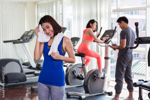 Happy Asian woman wiping in the gym .After the exercise.