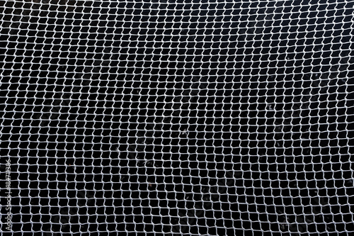 net of intertwined white rope / net protective in dark background