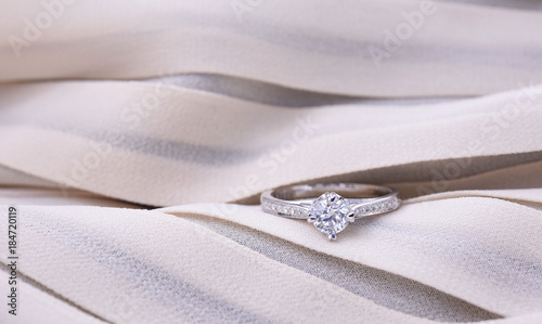 Diamond ring on silk texture , wedding ring romantic. 