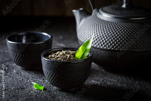 Closeup of green tea with teapot and cup