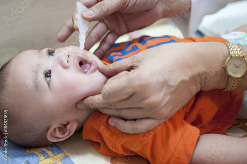 Oral vaccination of a baby boy