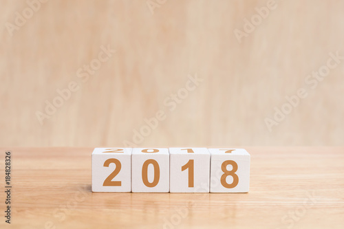 Wooden cubes with the numbers 2018 on wooden table. Merry christmas and Happy new year season with greeting card, illustration. copy space