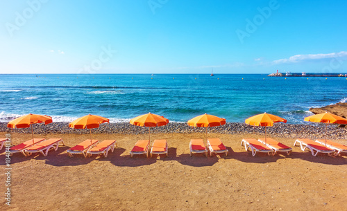 Umbrellas and chaise-longues on a beach