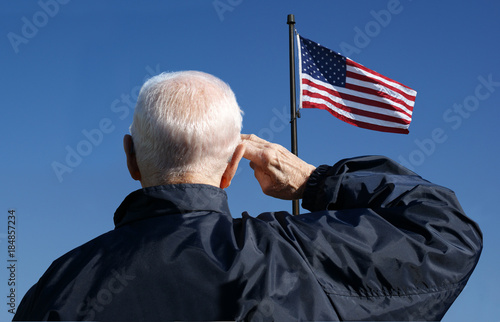 An American veteran salutes the American flag.