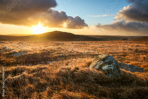 Brown willy tor on bodmin moor at sunrise with beautiful cloudy golden sky, cornwall, uk