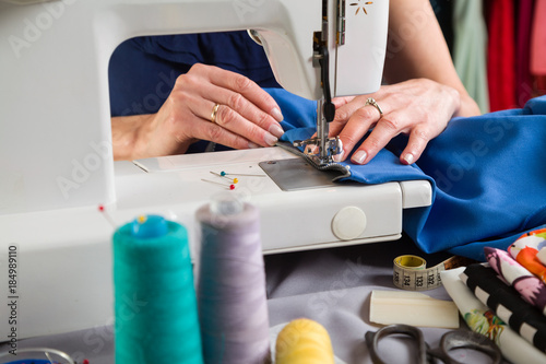 Sewing workshop. Sewing zipper on sewing machine.