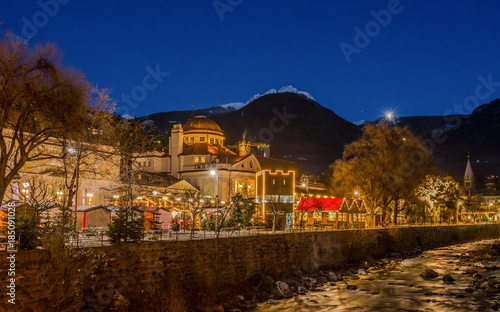 Meran Merano in South Tyrol, Italy, during the Christmas with christmans market by night . Beautiful light and great atmosphere