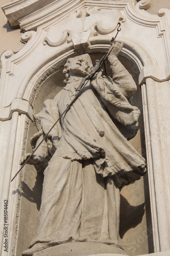 TREVIGLIO, October 28, 2017 - Closeup of the statue of a saint on the facade of the sacred church of Treviglio