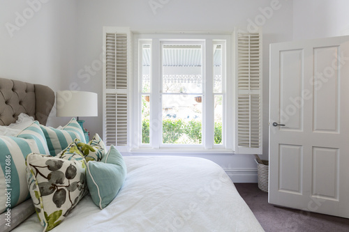 Bedroom window with a garden view in a luxury country house bedroom