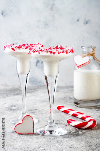 White chocolate peppermint martini with candy cane rim. Christmas holiday party drink idea