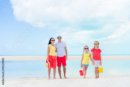 Family of four on beach vacation having a lot of fun