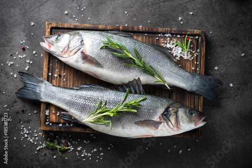 Fresh fish seabass on black background.