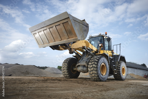 Excavator moving sand