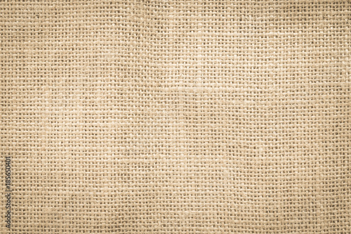 Jute hessian sackcloth woven burlap texture pattern background in old aged yellow beige cream gold brown color