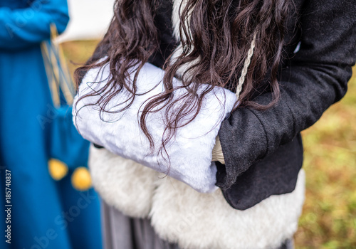 The girl is holding a muff for hands of fur