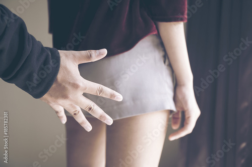 Hand of a man touching woman butt or ass or molest . Sexual harassment,Violence against women or Family or girl or friend, Workplace or office or college and outdoor bullying concept.