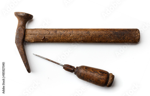 Shoemaker's tool: a hammer and awl on a white background closeup