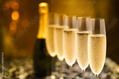 Many glasses of champagne in a line. Selective focus