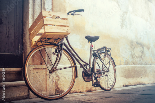 vintage bicycle with copy space, bike with wooden basket standing on a wall