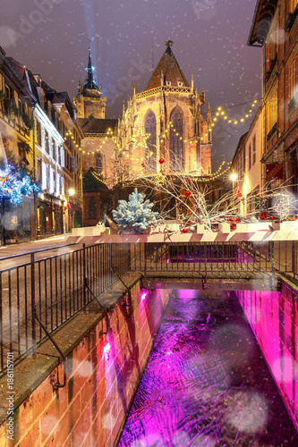 Saint Martin Church in old town of Colmar, decorated and illuminated at snowny christmas time, Alsace, France