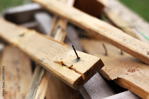 Rusty nail pierce the timber. Hazard of construction site from material. Occupational health and safety concept. Sources of tetanus germs.