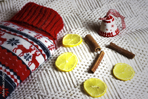 Hot water bottle, cinamon sticks and lemon slices